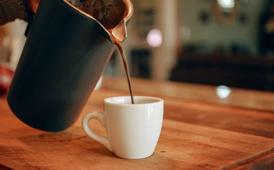 stream of coffee being poured into a cup Photo by Aidan Todd on Unsplash